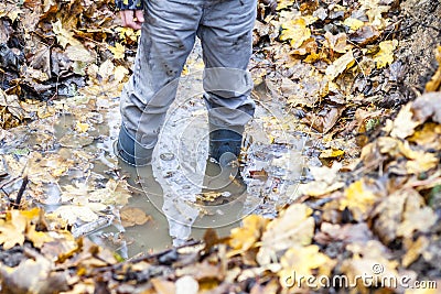 Little boy with wellys in the puddle Stock Photo