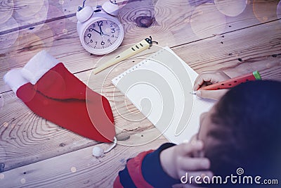 Little boy writing to Santa Claus. A kid writes a letter to Santa Claus. Child thinking, dreaming about Christmas wish Stock Photo