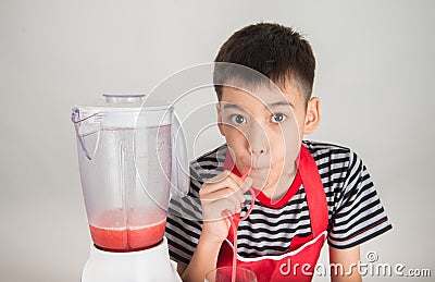 Little boys blend water melone juice by using blender home Stock Photo
