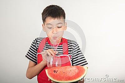 Little boys blend water melone juice by using blender home Stock Photo