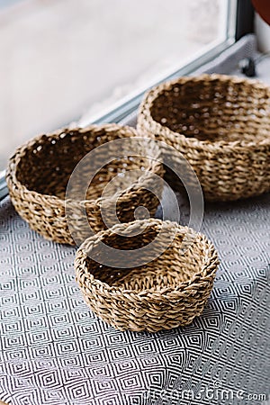 Little braided baskets of natural vines on the sub-house near the window. Eco storage concept Stock Photo