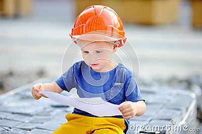 Little builder reading construction drawing Stock Photo