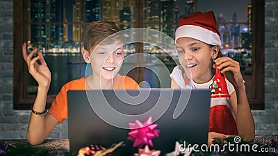 Little carol singers kids on video call with family celebrating Christmas during virtual party Stock Photo