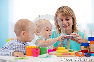 Little caucasian baby playing with Montessori toy in pre-school Stock Photo