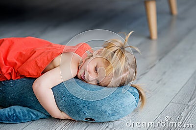 A little charming girl in a red dress is playing Stock Photo