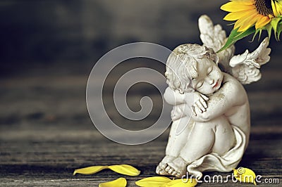 Little cherub on wooden background Stock Photo