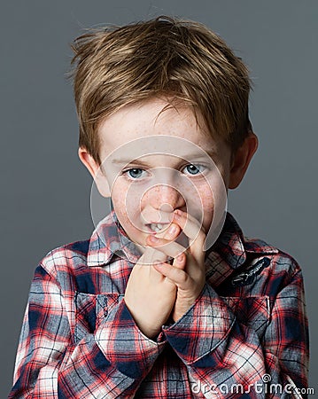 Little child biting fingers for boredom, stress or bad habit Stock Photo