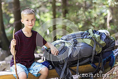 Little child boy with hikers backpack travelling in forest Stock Photo