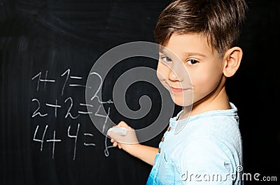 Little child with chalk doing math Stock Photo