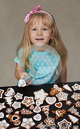 Little child decorating cookies with icing Stock Photo