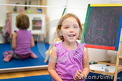 Little child is drawing with color chalk on the chalk board Stock Photo