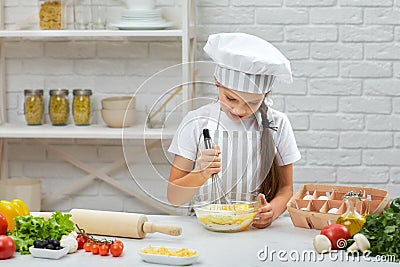 Little child girl kneads with corolla the dough Stock Photo