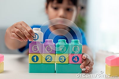 Little child girl playing colorful blocks Stock Photo