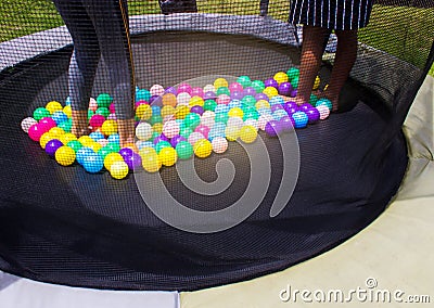 Little child jumping on trampoline in the playground Stock Photo