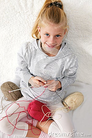 Little child learns to knit. Stock Photo