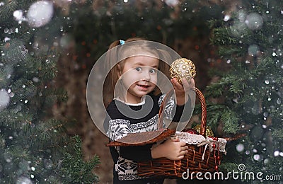 A little child by the New Year tree. Children decorate the Chris Stock Photo