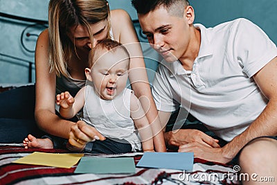 Parents playing educational game with daughter Stock Photo