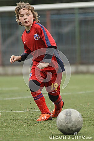 Little child playing football or soccer Editorial Stock Photo