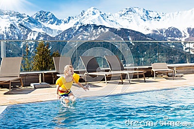 Child in outdoor swimming pool of alpine resort Stock Photo