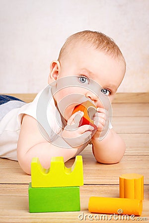 Little child playing with wooden bricks Stock Photo