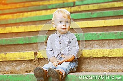 Little child sitting outdoors summer Stock Photo