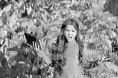 Little child unhappy learning in autumn park. Kid study with book. Keep studying. Small girl read book on autumn day Stock Photo