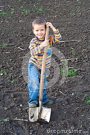 Little children with big shovel Stock Photo