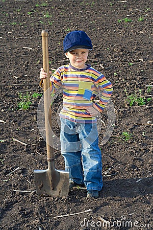 Little children with big shovel Stock Photo