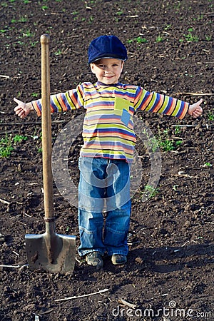 Little children with big shovel Stock Photo