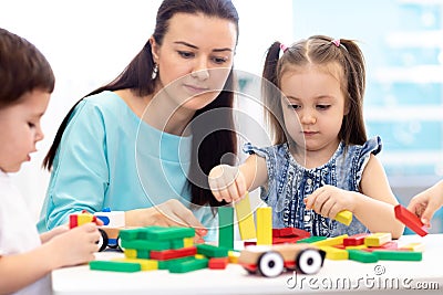 Little children building block toys at home or daycare. Kids playing with color blocks. Educational toys for preschool Stock Photo