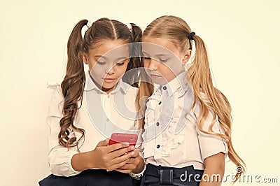 Little children depend on mobile phone. Girls text sms with mobile phone. depend. Stock Photo