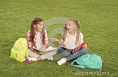 Little children girls read books sit on grass, summer school concept Stock Photo