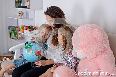 Little children with a nanny or with a young mother or with a t Stock Photo
