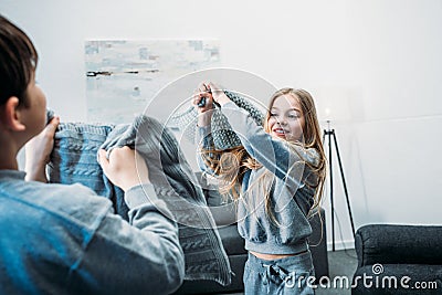 Little children in pajamas having pillow fight at home Stock Photo