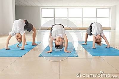 Little children practicing yoga indoors Stock Photo