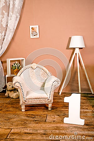 Little children's room interior in photo studio. Hall with tiny cute chair, vintage armchair, lamp. Photoshoot for Stock Photo