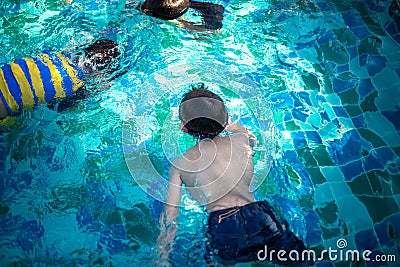 Children swimming in pool Stock Photo