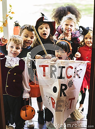 Little children trick or treating on Halloween Stock Photo