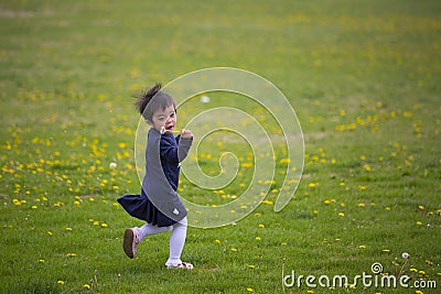 Happy gril running on dandelion field Stock Photo