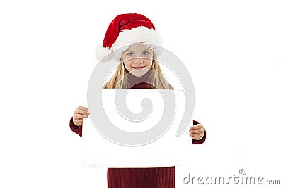Little Christmas girl presenting. Adorable little girl holding a blank paper. Stock Photo