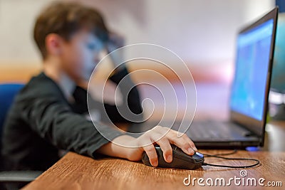 Little computer dependent gamer boy playing on laptop Stock Photo