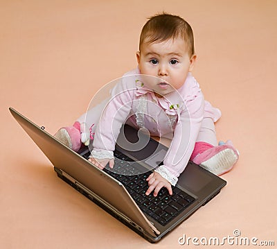 Little computer genius baby girl with laptop Stock Photo