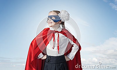 Girl power concept with cute kid guardian against sky background Stock Photo