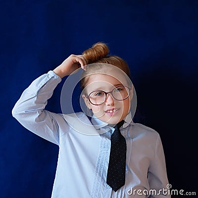 Little confused schoolgirl scratching head Stock Photo