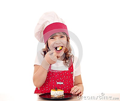 Little cook girl eat cake Stock Photo