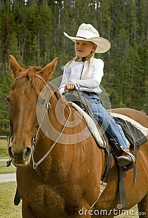 Little Cowgirl on Her Horse Stock Photo