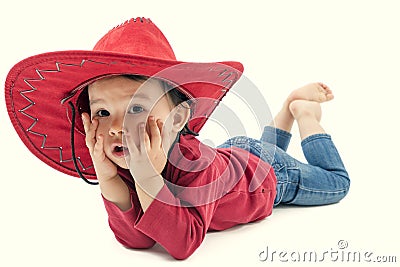 Little cowgirl in a red hat posing on a white Stock Photo