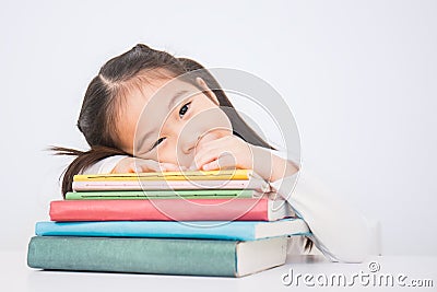 Little cute asian girl thinkig with stack of books ready to school. Stock Photo