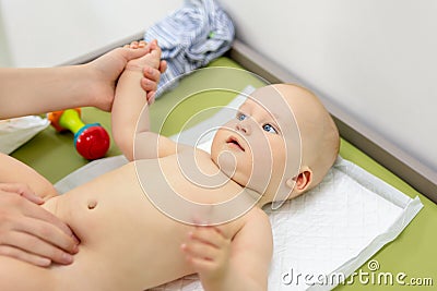 Little cute baby boy visiting doctor . Pediatrician make check up and examining infant for disease prevention protocol Stock Photo