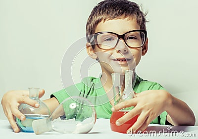 Little cute boy with medicine glass wearing glasses smiling, small genious, lifestyle people concept Stock Photo